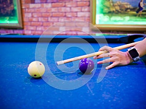 Hands aiming white ball to shot close up