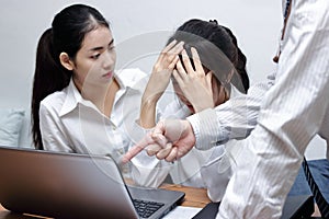 Hands of angry male boss pointing fingers and blaming young Asian employee in office.