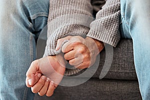 Hands, anxiety and closeup of a man with depression, mental health problem and stress in home lounge. Male person on a