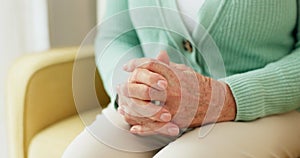 Hands, anxiety and senior woman on a sofa with stress, fear or grief, dementia or scared in her home. Stress, worry and