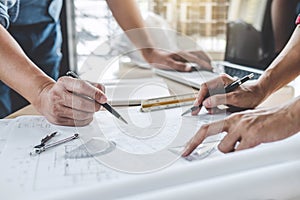 Hands of architect or engineer working on blueprint meeting for project working with partner on model building and engineering