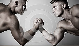 Hands or arms of man. Muscular hand. Two hands. Muscular men measuring forces, arms. Two men arm wrestling. Rivalry