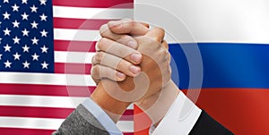 Hands armwrestling over american and russian flags