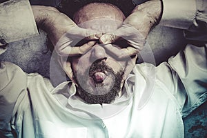 Hands as a mask, man in white shirt with funny expressions