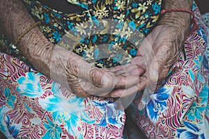 Hands Asian elderly woman grasps her hand on lap