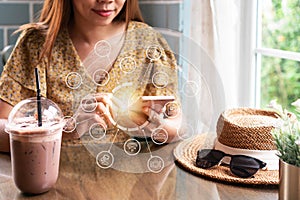 Hands of Asian girl using mobile phone for shopping online in cafe. Food and beverage, technology and lifestyle concept. Close up