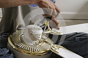 Hands assembling a Ceiling Fan
