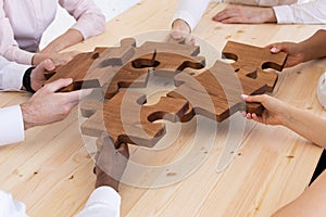 Hands assembling jigsaw puzzle