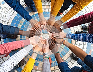 Hands assembling a mosaic of interlocking puzzle pieces