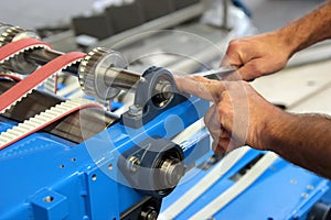 Hands of an attendant while assembling a machine