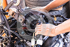 Hands of Auto mechanic working on car engine in mechanics garage, Repair and Maintenance service