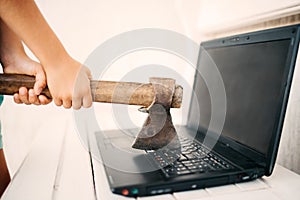 Hands with an ax and a laptop photo