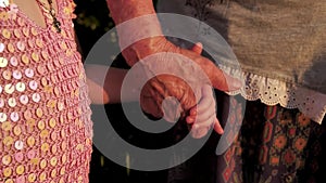 Hands of baby and grandmother