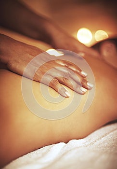 Hands, back massage and masseuse with woman at spa for luxury, calm and relaxing pamper routine. Beauty, aromatherapy photo