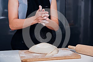 Hands of baker woman female making clapping flour dough