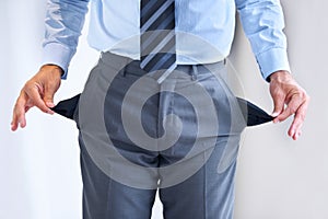 Hands, bankrupt and broke with pockets of a business person in studio on a white background. Economy, debt or financial