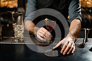 Hands of a bartender at bar restaurant with wineglass