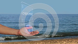 Hands on beach hold hologram text Cyber attack