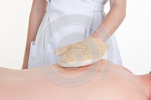 Hands of beautician on back of a Natural luff sponge