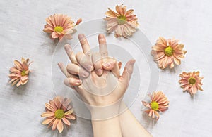 Hands of a beautiful woman on a white background. Delicate palm with natural manicure, clean skin. Light white nails. Hand Care
