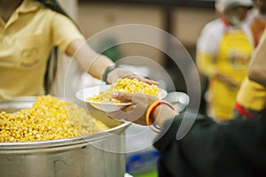 The hands of beggars receive donated food as a share in society : the concept of hunger