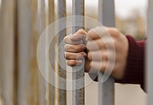 Hands behind bars