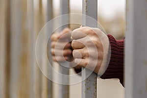 Hands behind bars