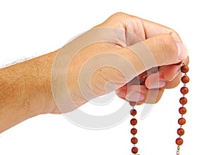 Hands of a believer with wooden rosary