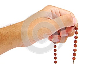 Hands of a believer with wooden rosary photo