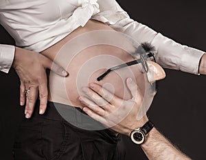 Hands and Belly - Pregnant woman belly holding hands of mother, father and child