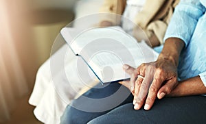 Hands, bible and senior couple praying in their home together for scripture, faith and trust. Family, worship and praise