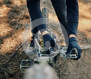 Hands, bicycle and repair pedal in woods for speed, dirt and nature in summer for extreme sport athlete. Man, Mountain