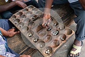 Hands of Black African People playing Mancala game, Dar Es Salaam, Tanzania. Mancala or Bao is a game which is very