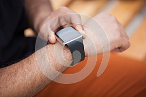 Hands of black man using modern smart wrist watch