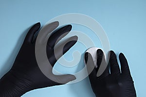 Hands in black nitrile gloves