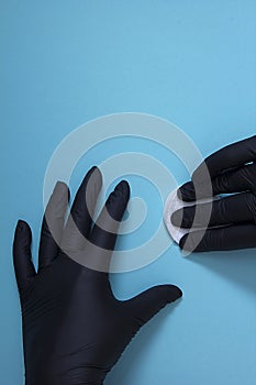 Hands in black nitrile gloves