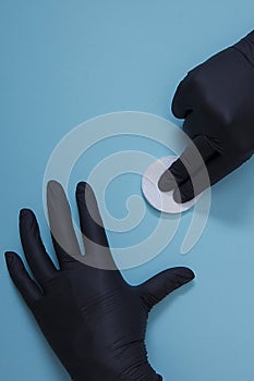 Hands in black nitrile gloves