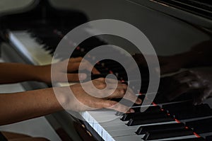 Hands on black and white piano keys