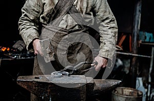 The hands of a blacksmith at work in the smithy
