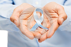 Hands with blue prostate cancer awareness ribbon