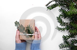 Hands in a blue sweater hold hand made gift photo