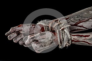 Hands bound,bloody hands, mud, rope, on a black background, isolated, kidnapping, zombie, demon
