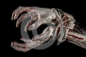 Hands bound,bloody hands, mud, rope, on a black background, isolated, kidnapping, zombie, demon