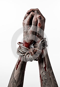 Hands bound,bloody hands, mud, rope, on a white background, isolated, kidnapping, zombie, demon