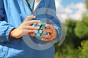 Hands of boy with magic cube outdoor