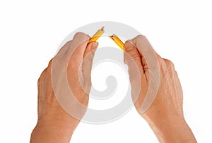 Hands breaking pencil