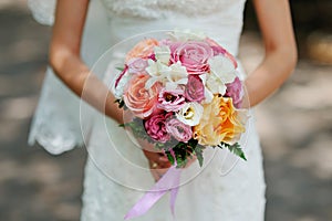 Hands of the bride beautiful wedding bouquet