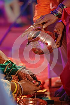 Hands of bride is decorated beautifully by indian mehndi art along with jeweleryâ€™s and colorful bangles