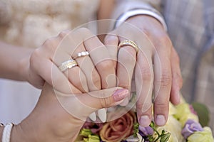 Hands of the bride and groom with rings 3