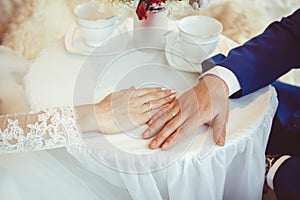 Hands of the bride and groom with rings